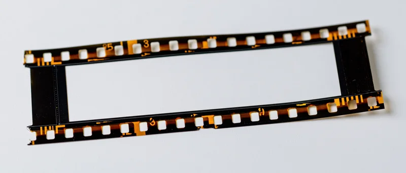 Blank 35mm film strip laid flat on white background