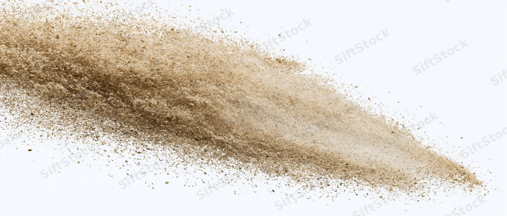 Airborne sand particles scattered mid-flight against white background