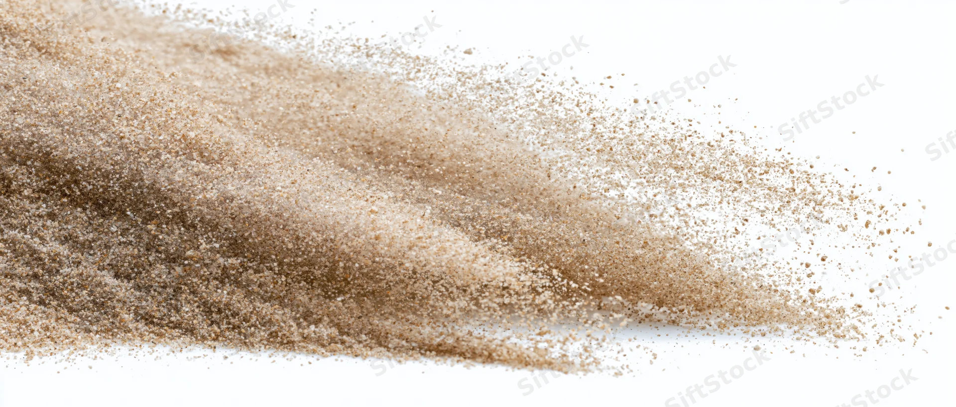 Fine desert sand dispersing mid-air in a dynamic wave against white background