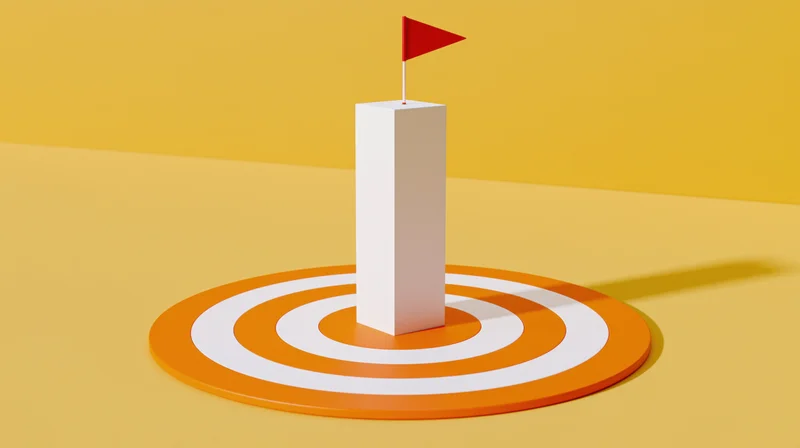 White pillar with red flag at center of orange and white target on yellow background