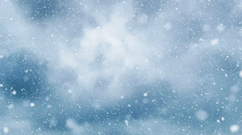 Snowflakes drifting in a cloudy winter sky