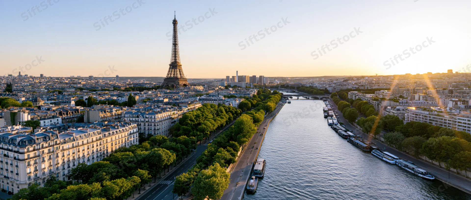 Aerial panoramic view of paris cityscape with eiffel tower and seine river at sunset