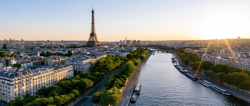Aerial panoramic view of paris cityscape with eiffel tower and seine river at sunset