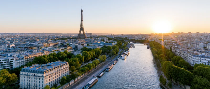 Aerial panoramic view of paris at sunset with eiffel tower and river seine