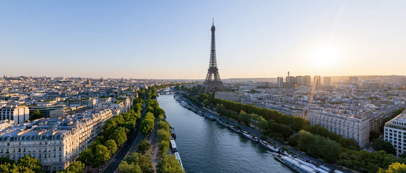Aerial panoramic view of paris cityscape with eiffel tower and seine river at sunset