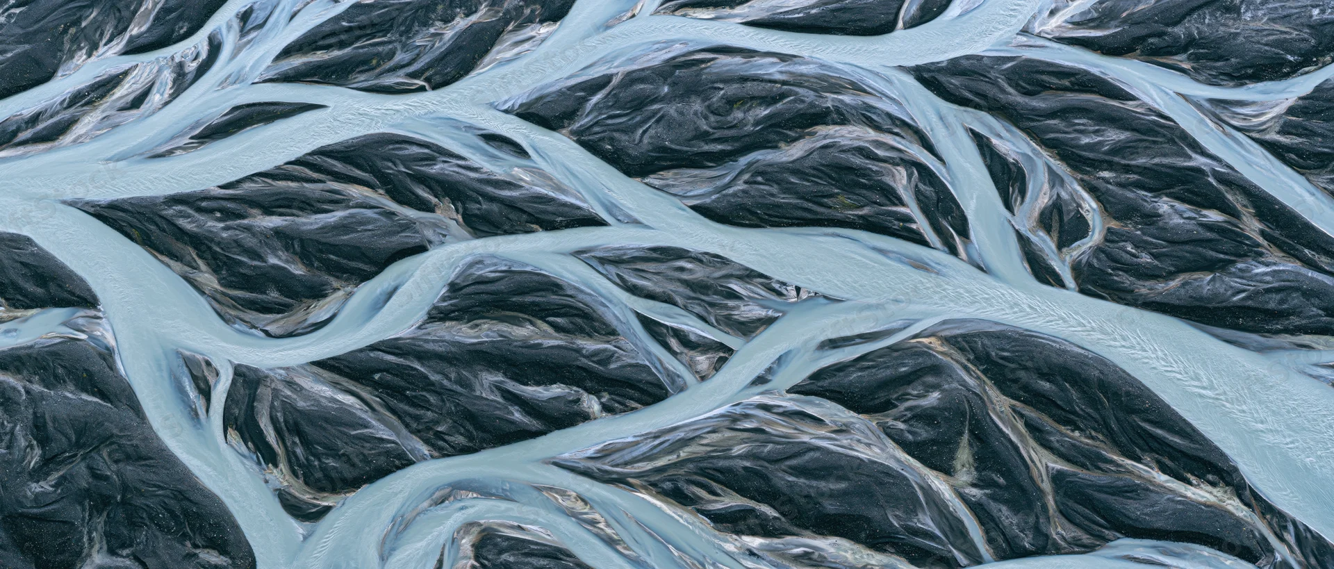 Aerial top-down view of a braided glacial river delta in Iceland
