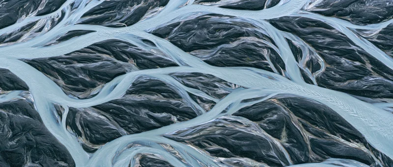 Aerial top-down view of a braided glacial river delta in Iceland