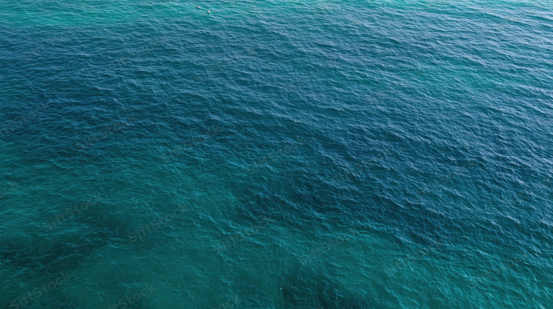 Aerial top-down view of open ocean surface filling the entire frame