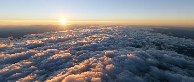 Aerial view of a vast cloud layer at sunrise from high altitude