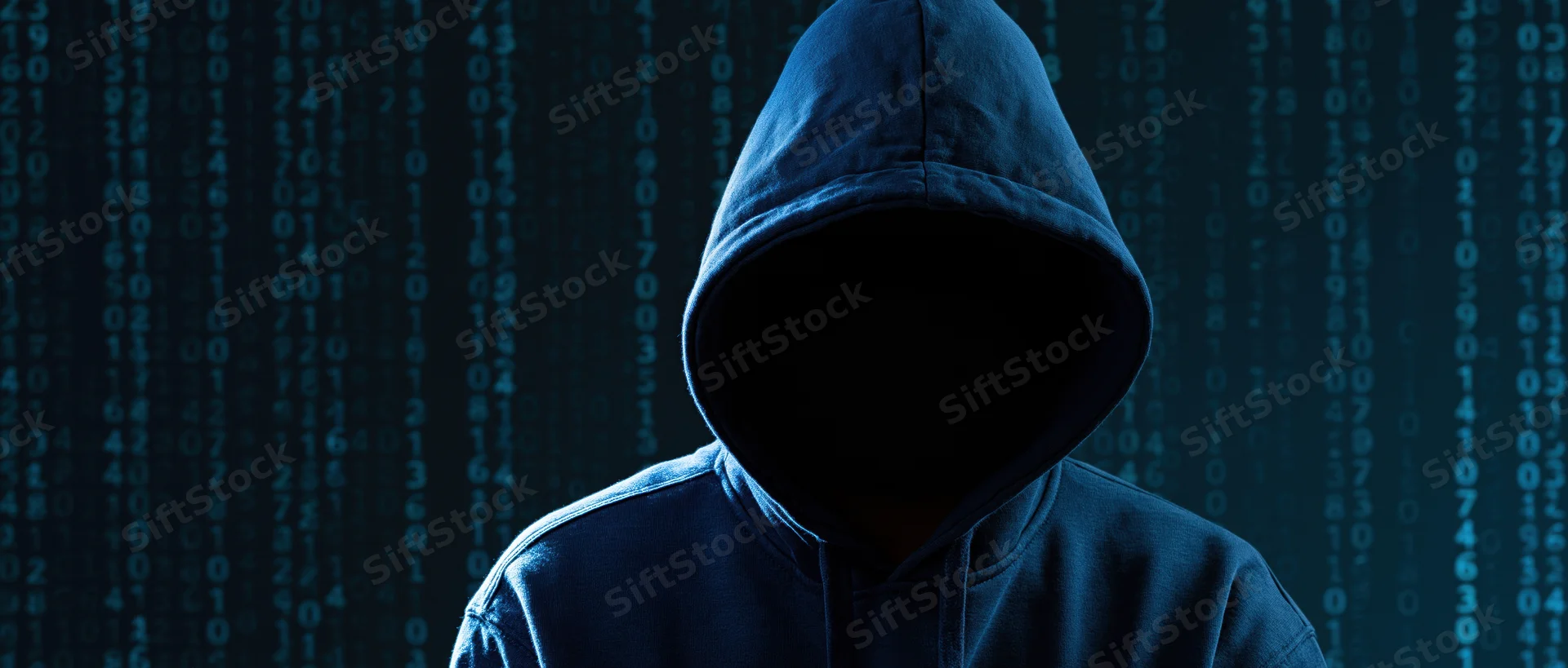 Hooded figure with hidden face standing before digital code display