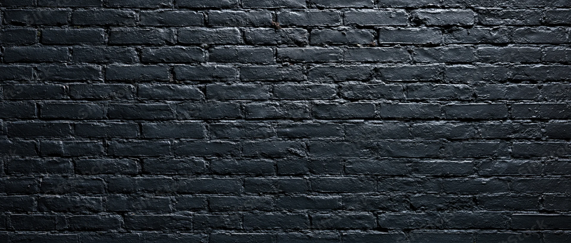 Black-painted brick wall filling the frame as a textured background