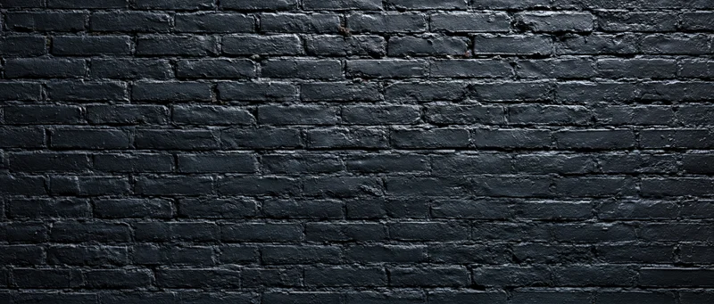 Black-painted brick wall filling the frame as a textured background