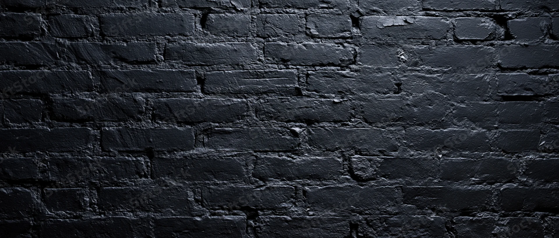 Black-painted brick wall filling the frame as a textured background