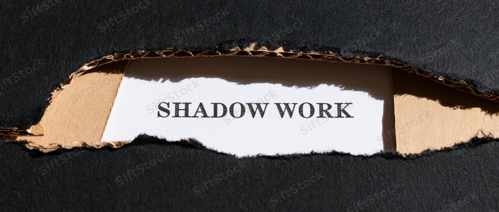Torn black cardboard revealing white paper with shadow work text
