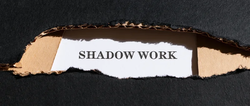 Torn black cardboard revealing white paper with shadow work text