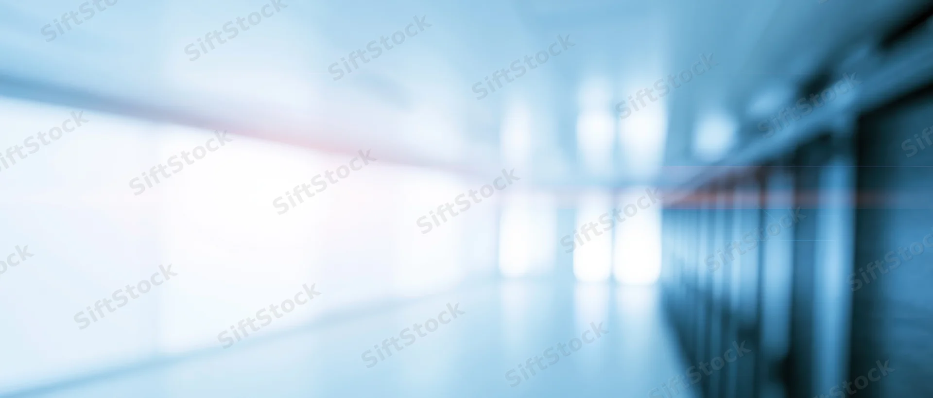 Blurred interior of a server room corridor with racks and cooling lights