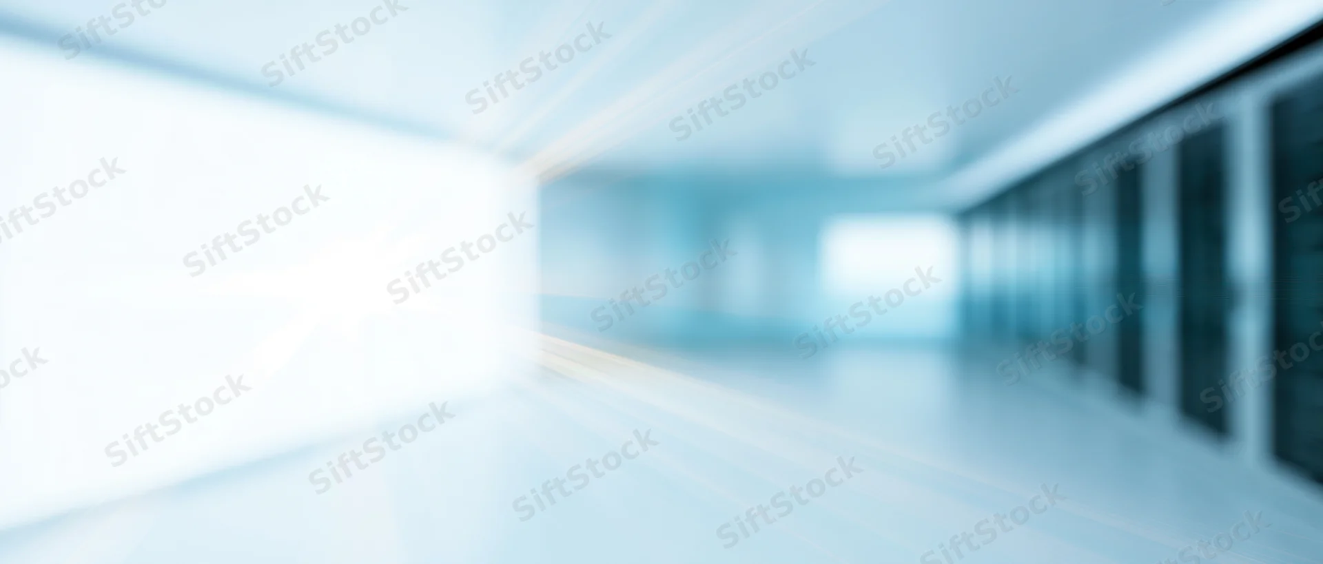 Blurred interior of a server room with rows of racks and bright lighting