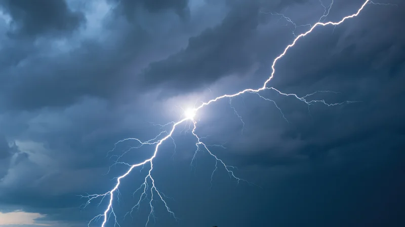 Bright lightning bolt splitting across dark stormy sky