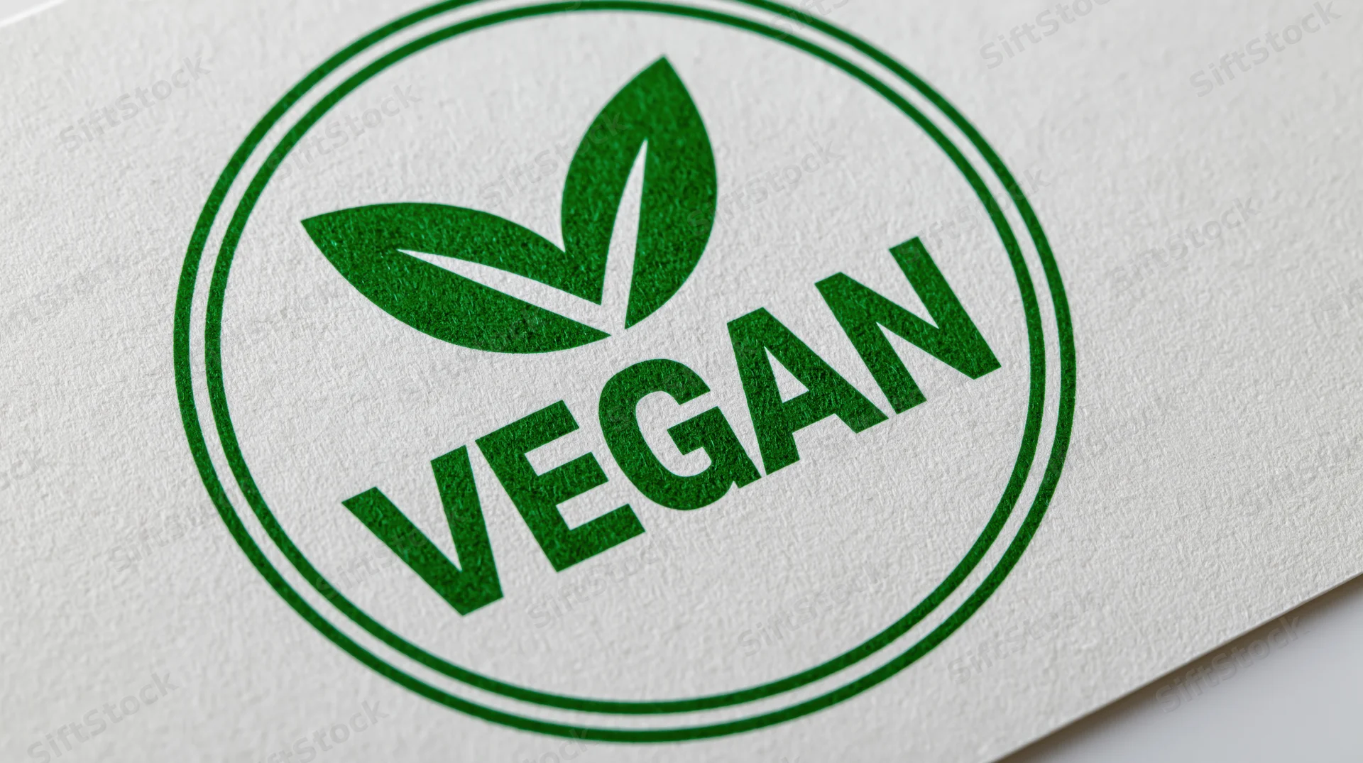 Circular green vegan certification badge printed on white paper
