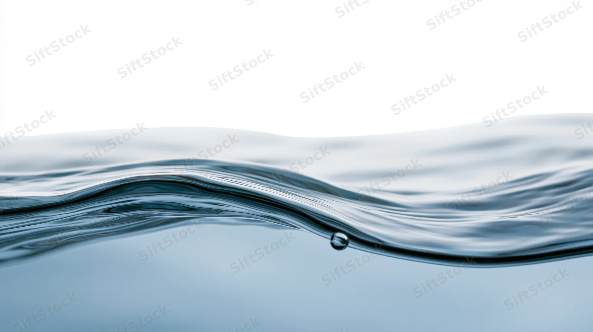 Close-up of a calm water surface with a small droplet and gentle wave against a white background