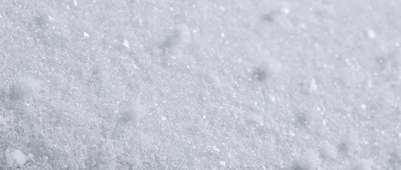 Close-up of falling snowflakes on a snowy surface