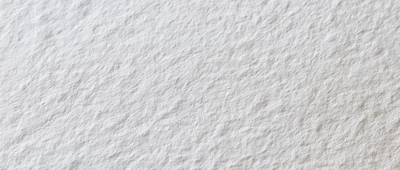 Close-up of a blank sheet of cold-press watercolor paper with textured surface