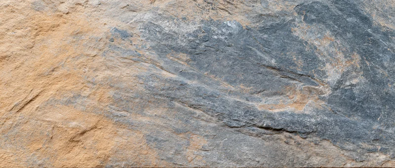 Close-up of natural stone surface with layered texture and earthy tones