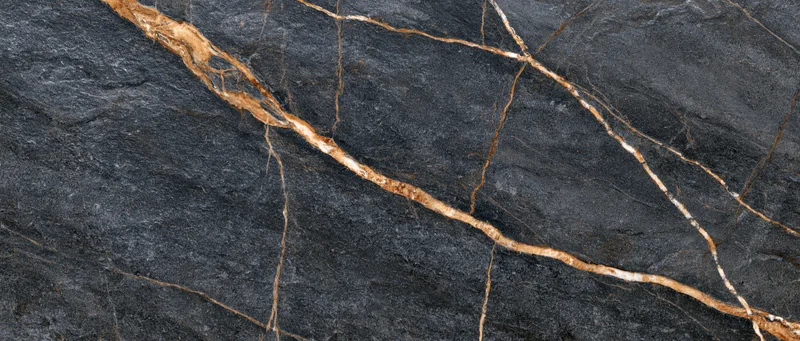 Close-up of polished black marble slab with gold veining for interior design
