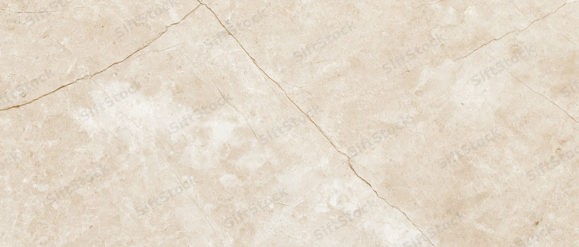 Close-up of a polished cream marble slab surface with natural veining and texture