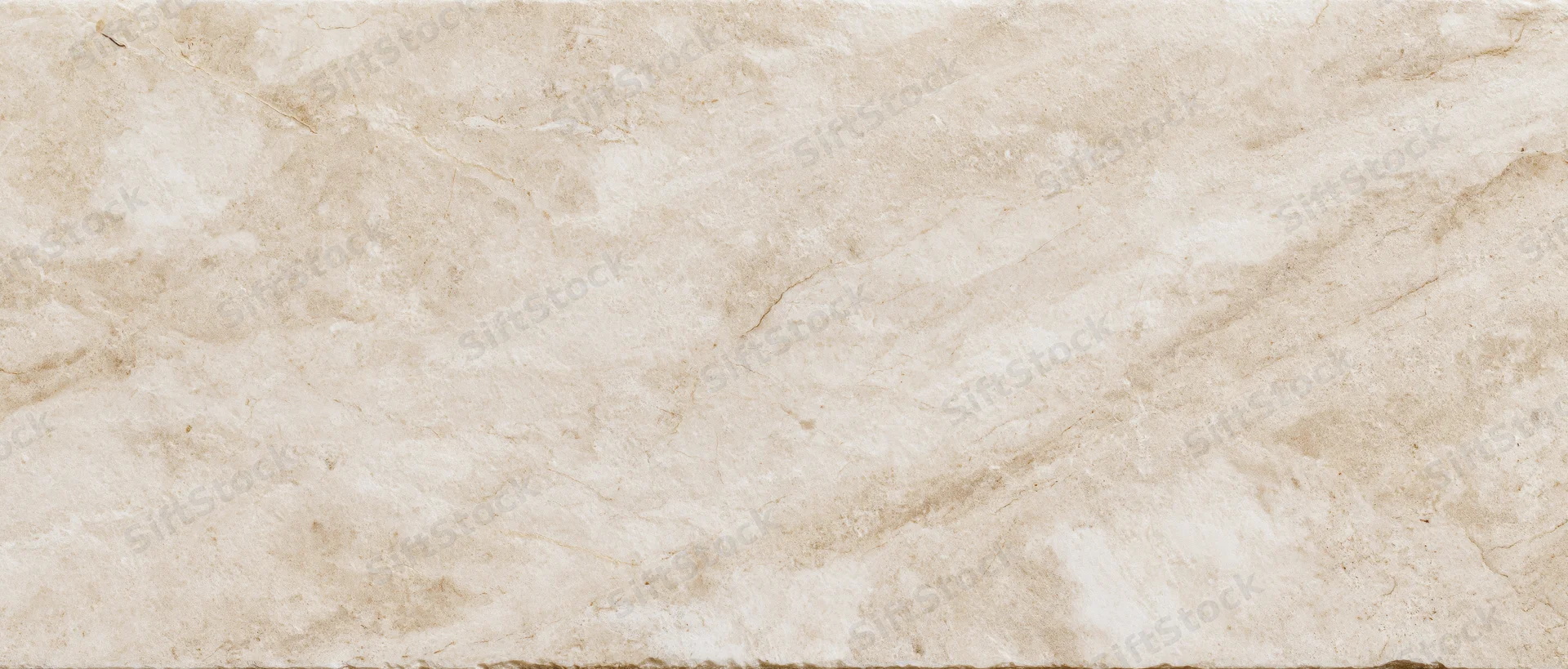 Close-up of a polished cream marble slab surface with natural veining and texture