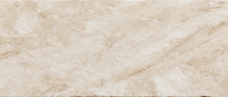 Close-up of a polished cream marble slab surface with natural veining and texture