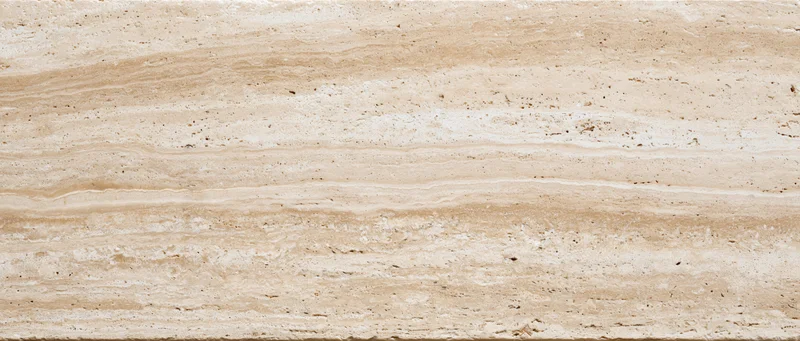 Close-up of a polished travertine stone surface with natural veining and layered texture