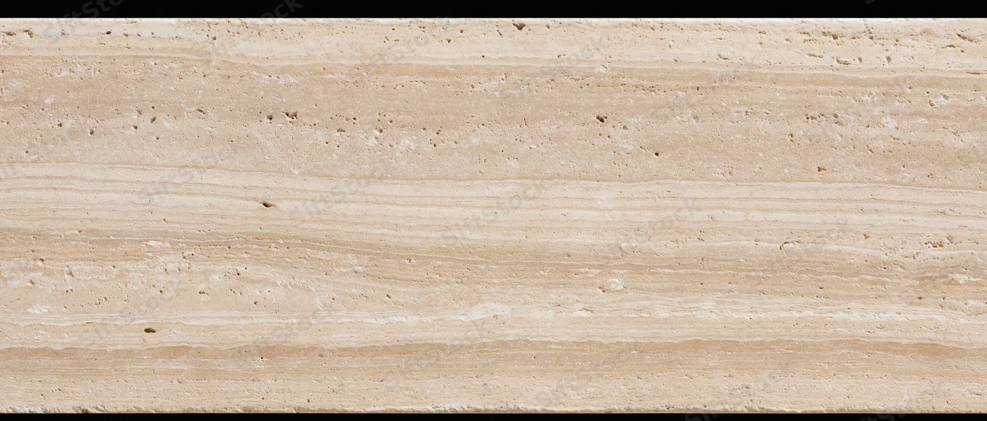 Close-up of a polished travertine stone surface with natural striations and texture