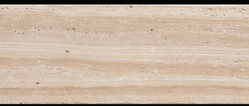 Close-up of a polished travertine stone surface with natural striations and texture