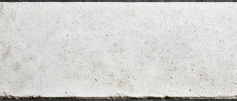 Close-up of a rough concrete wall surface with speckled texture and horizontal edges
