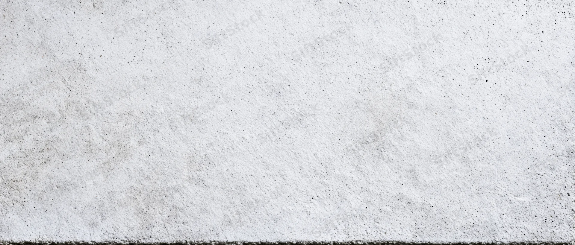 Close-up of a raw concrete wall surface with rough texture and gray tone