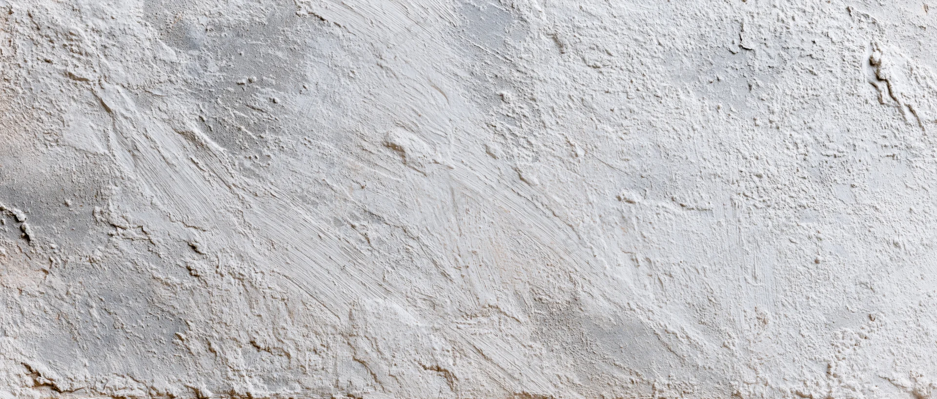 Close-up of a rough concrete wall surface with visible texture and imperfections