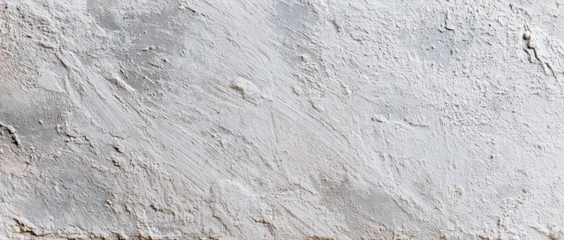 Close-up of a rough concrete wall surface with visible texture and imperfections