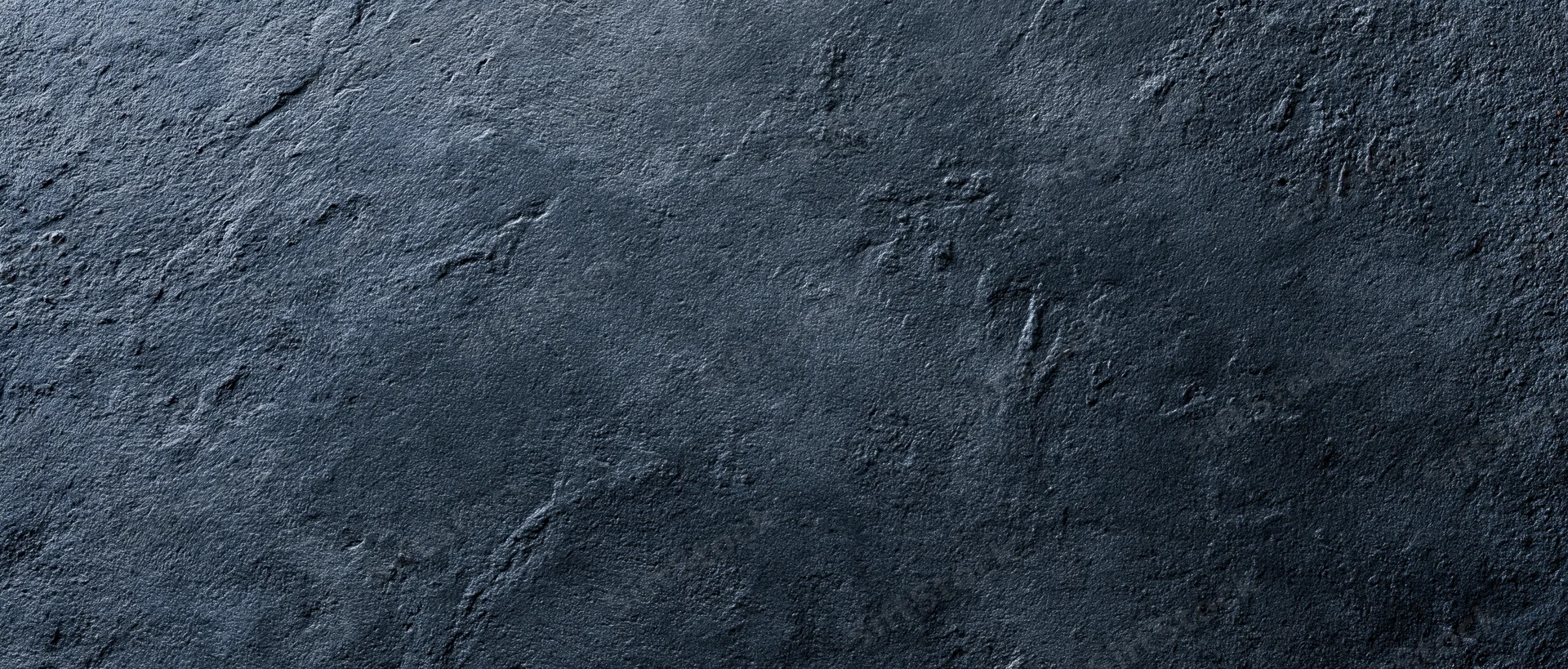 Close-up of rough dark concrete wall surface