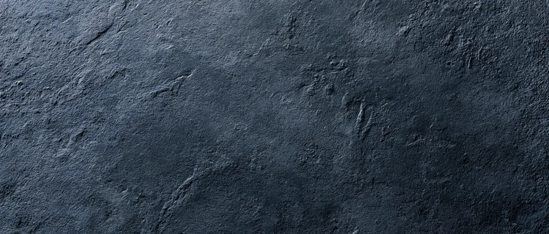 Close-up of rough dark concrete wall surface