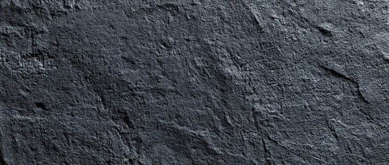 Close-up of rough dark concrete wall surface