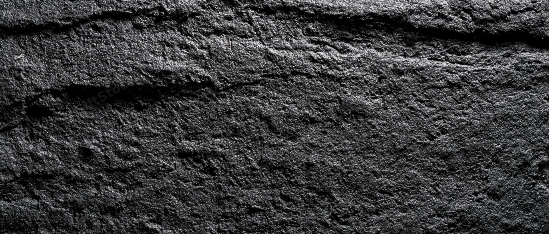 Close-up of rough dark concrete wall surface