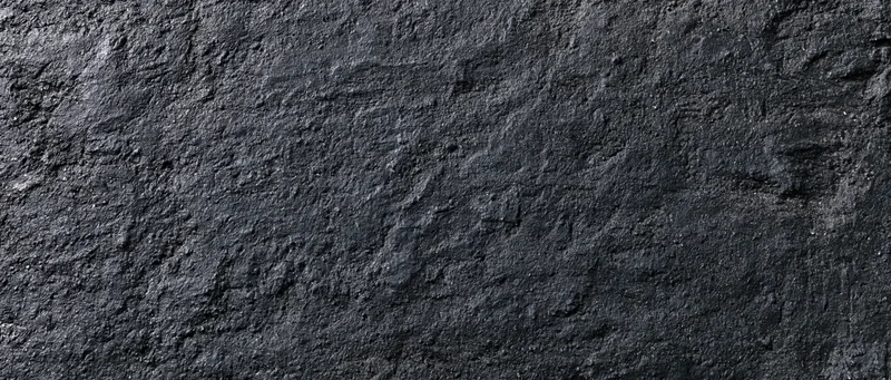 Close-up of rough dark concrete wall surface