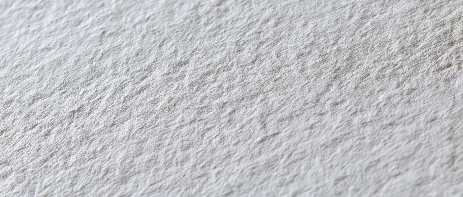 Close-up of textured white cold-press watercolor paper surface