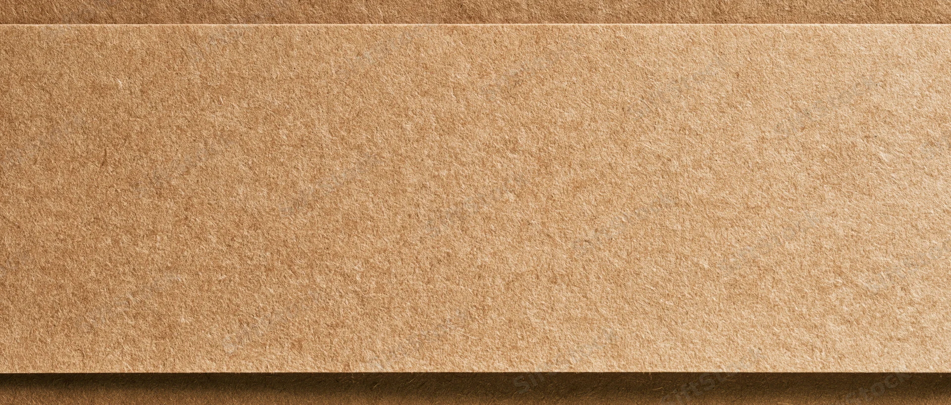 Close-up flat lay of a sheet of kraft paper filling the entire frame