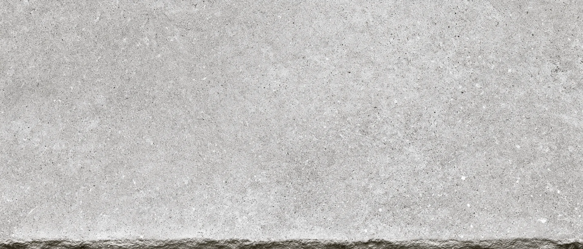 Close-up of a smooth concrete surface with visible texture and fine aggregate details