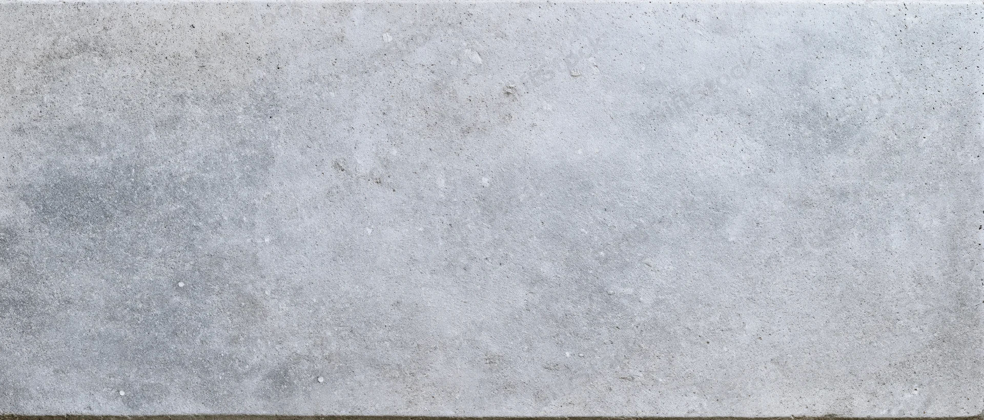 Close-up flat lay of a smooth gray concrete surface