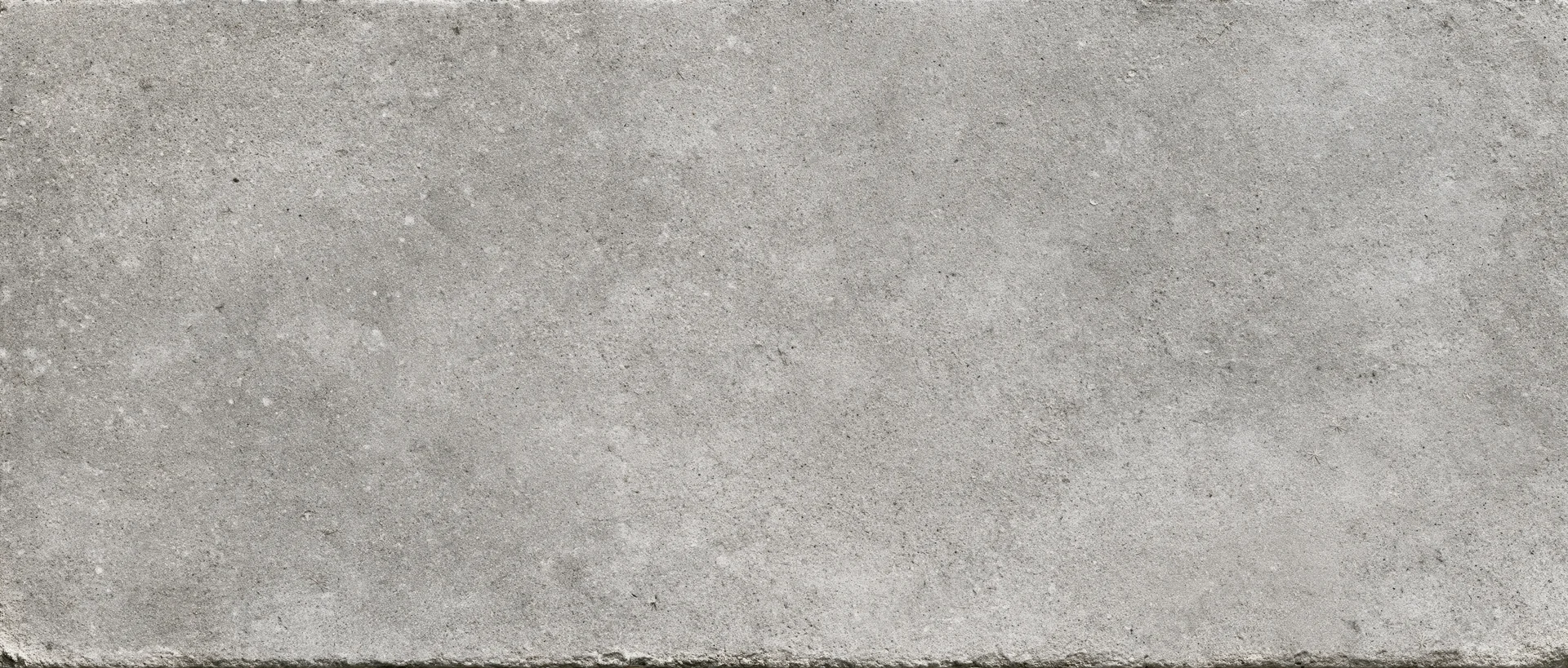 Close-up flat lay of a smooth concrete surface filling the frame