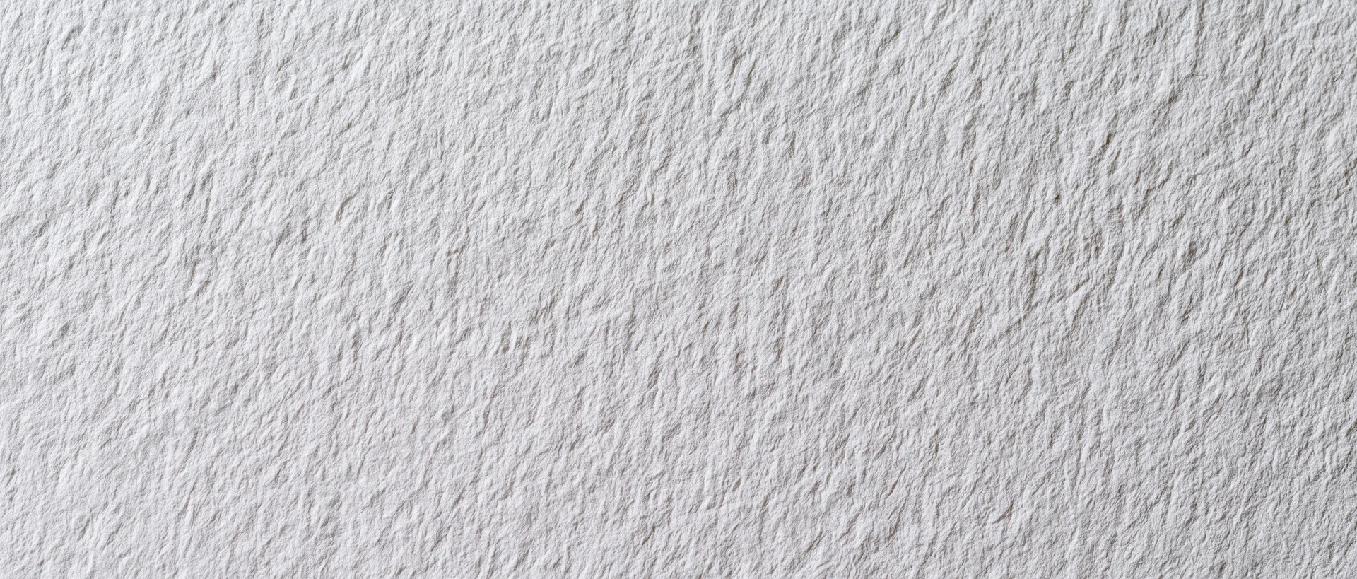 Close-up of white textured paper or linen wallpaper surface