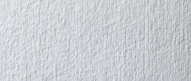 Close-up of white textured paper or linen wallpaper surface